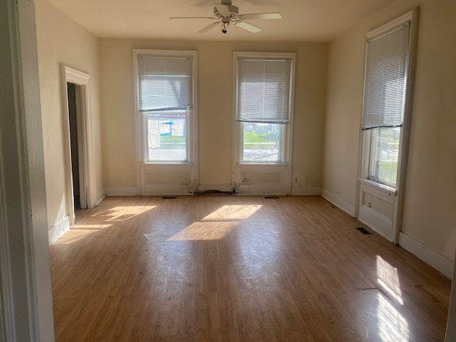 930 North Main Street Rochelle, IL 61068 - Photo 8 of 18 an empty room with wooden floor and windows