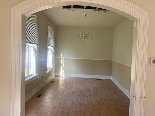 930 North Main Street Rochelle, IL 61068 - Photo 9 of 18 an empty room with wooden floor fan and windows