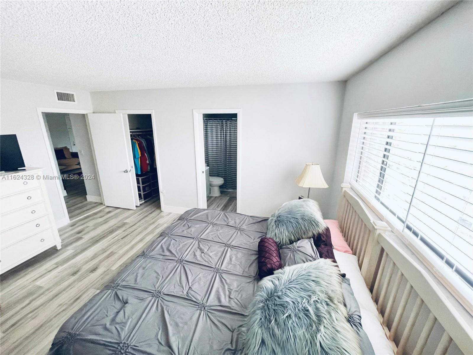 8540 Southwest 133rd Avenue Road, Unit 414 Miami, FL 33183 - Photo 3 of 15 Primary with space for King bed, walk-in closet, ensuite bathroom.