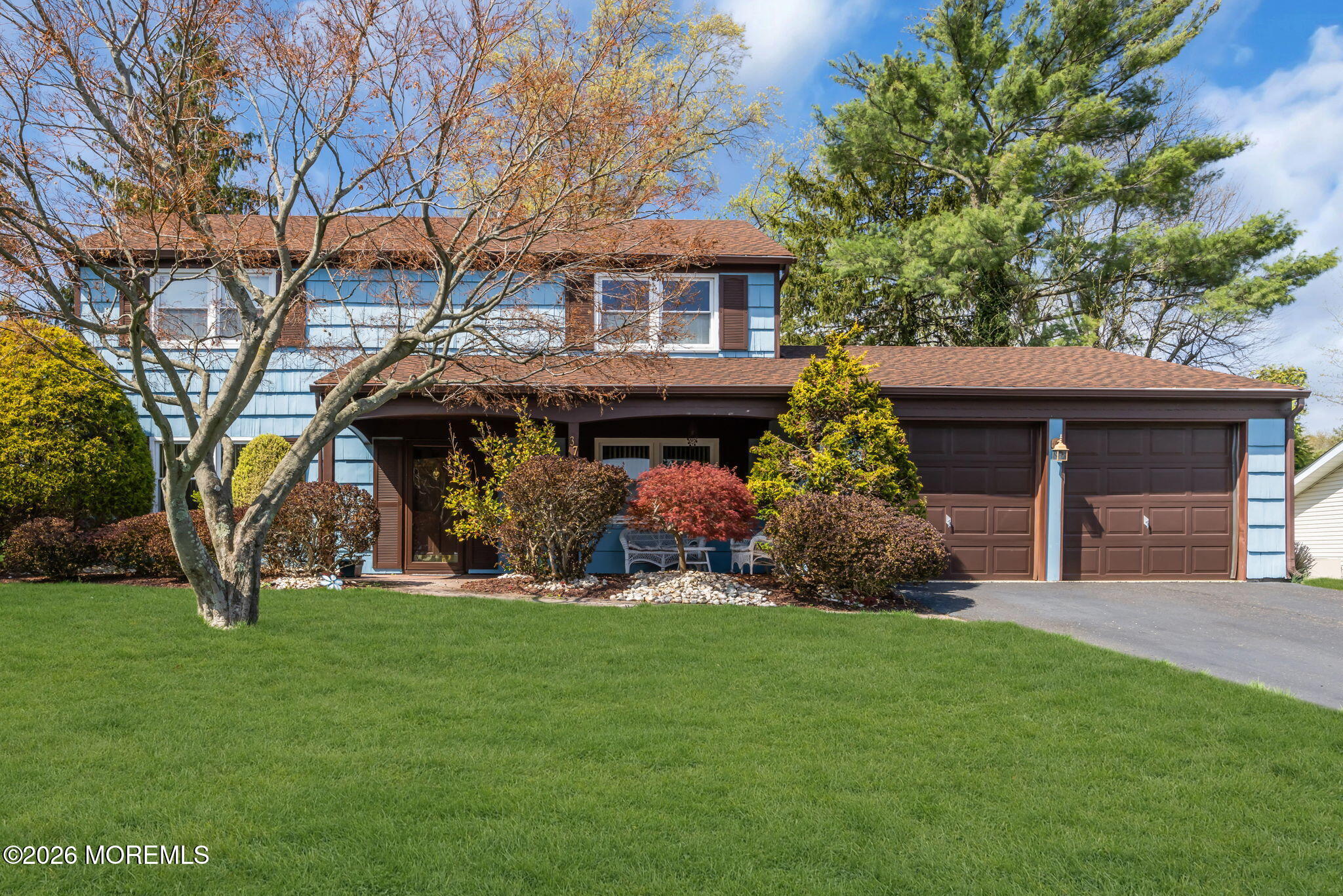 37 Faith Lane Aberdeen, NJ 07747 - Photo 1 of 36 a front view of a house with a garden and trees