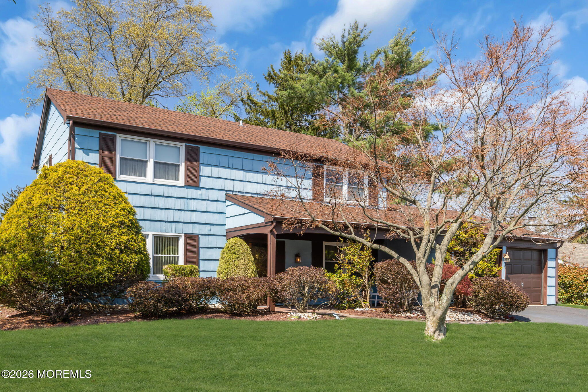 37 Faith Lane Aberdeen, NJ 07747 - Photo 2 of 36 a front view of a house with a garden and plants