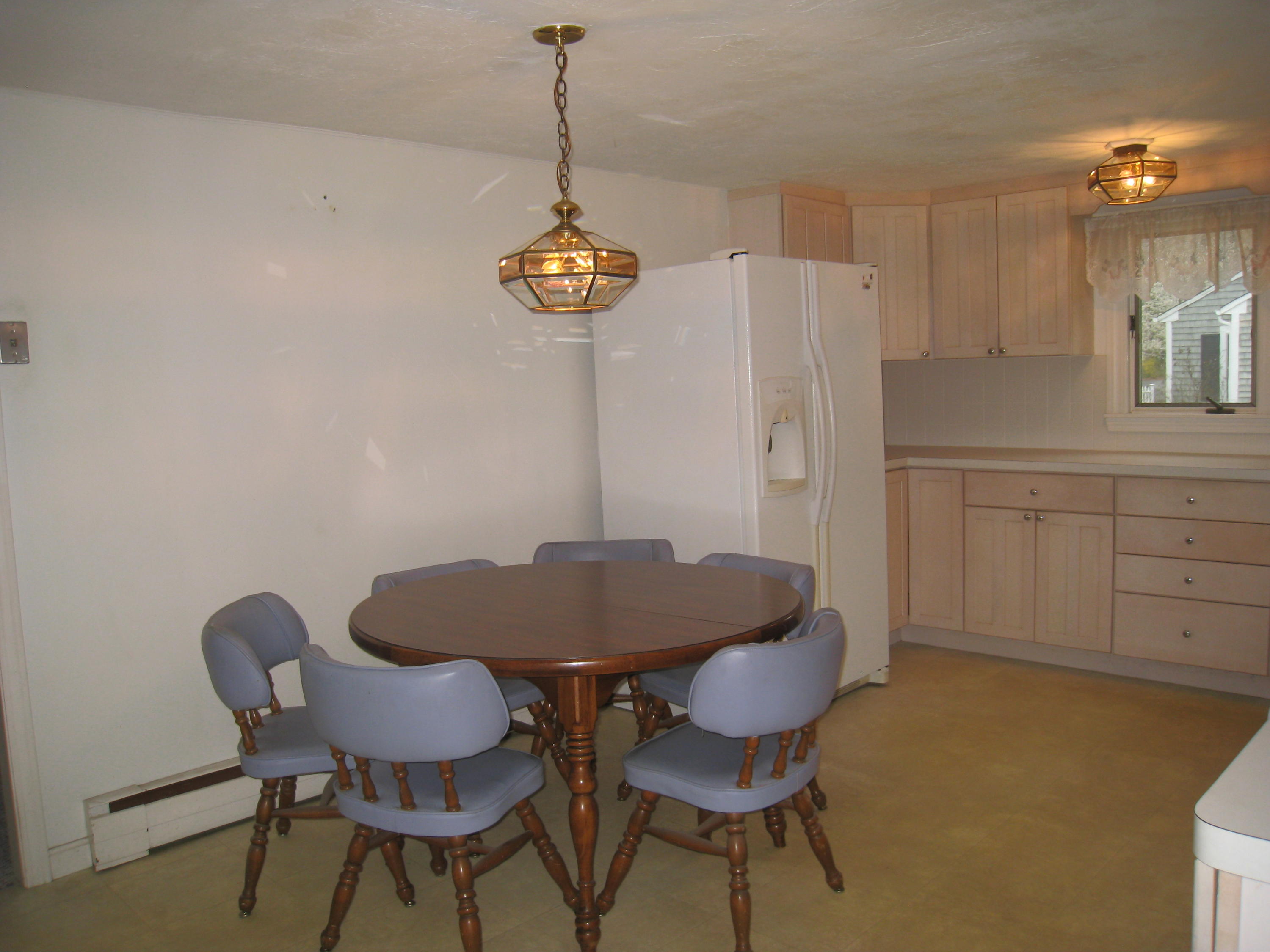 34 Tevyaw Road Hyannis, MA 02601 - Photo 6 of 28 a view of a dining room with furniture and chandelier