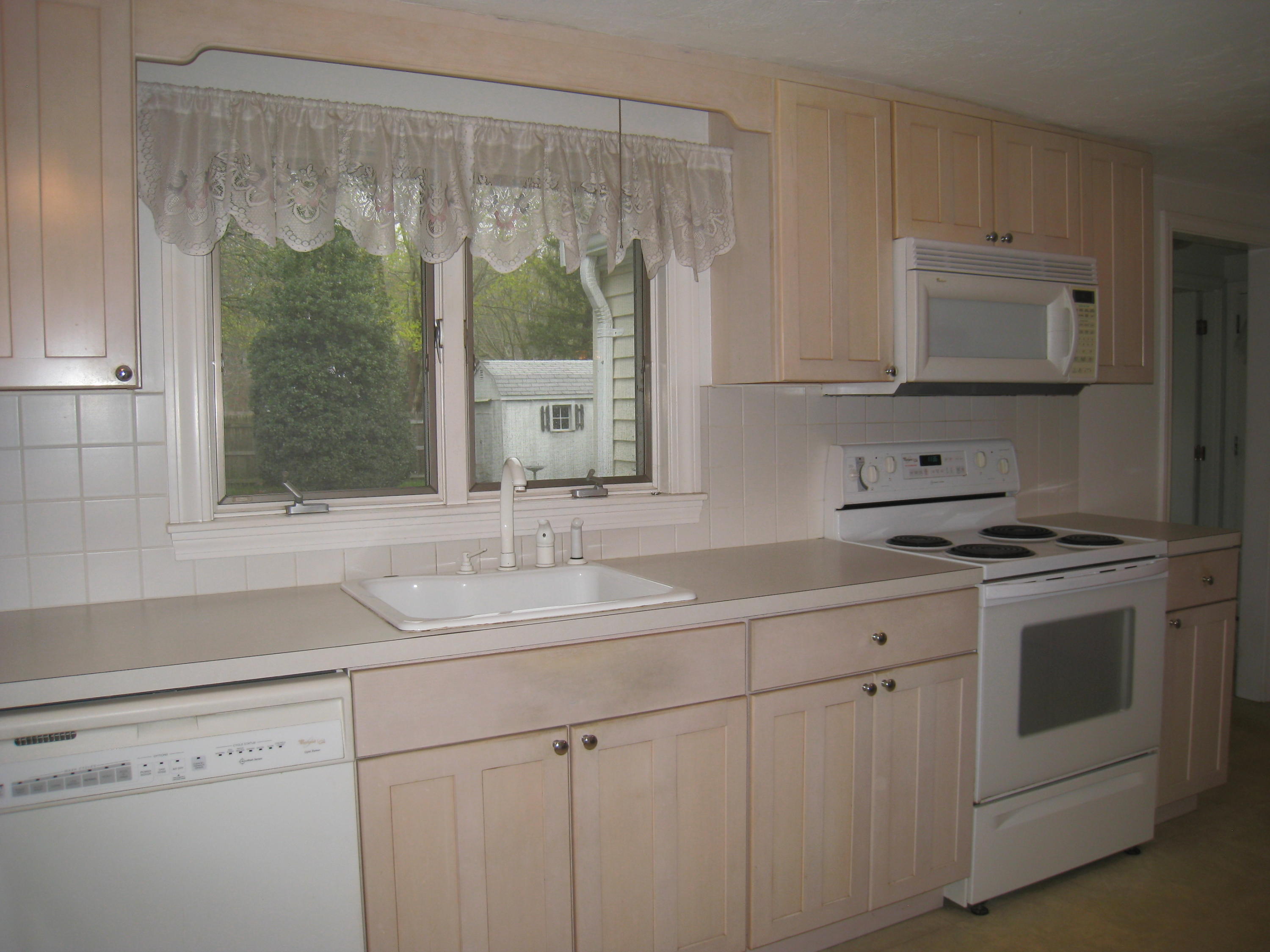 34 Tevyaw Road Hyannis, MA 02601 - Photo 8 of 28 a kitchen with a sink stove and cabinets