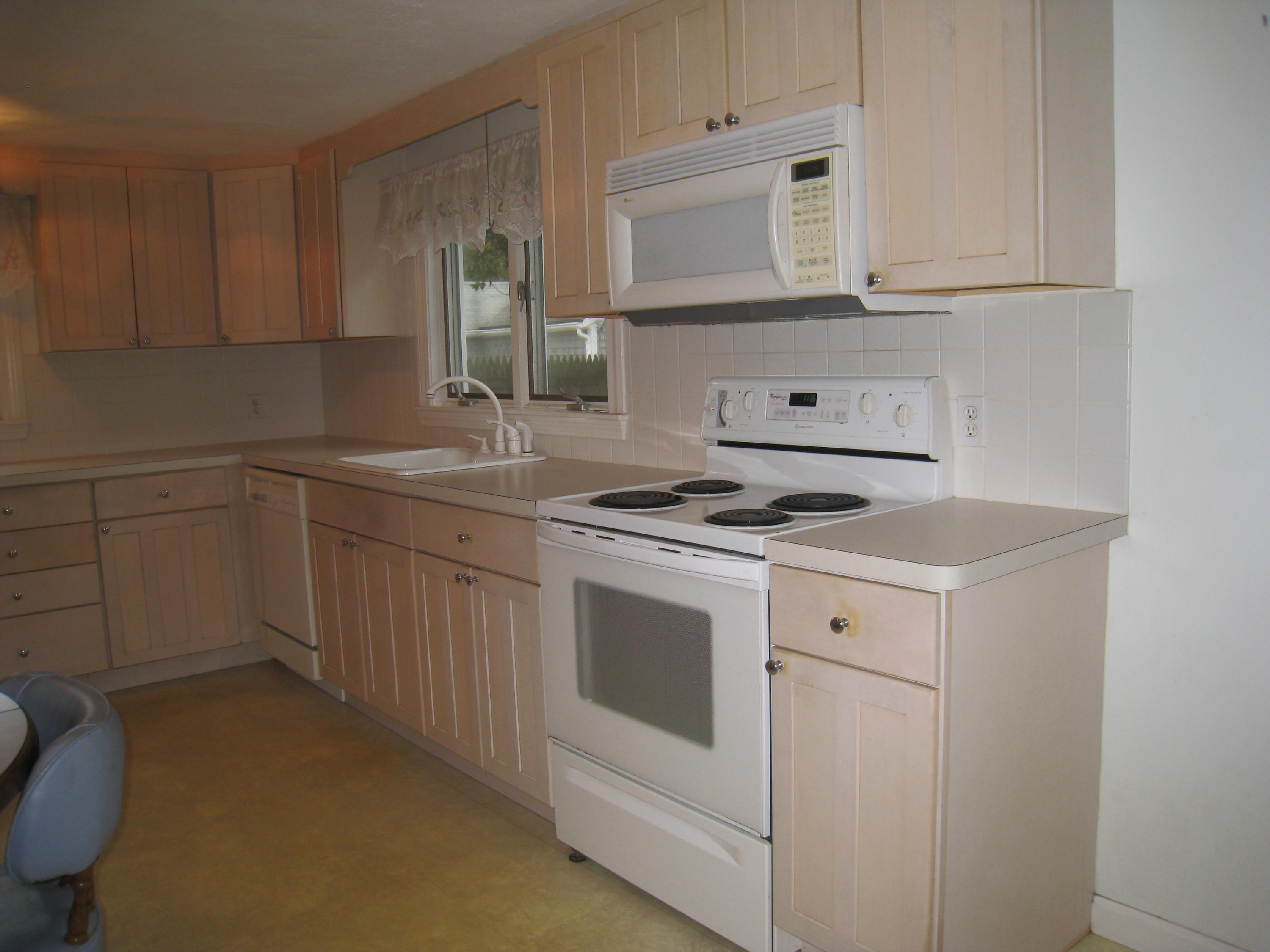 34 Tevyaw Road Hyannis, MA 02601 - Photo 10 of 28 a kitchen with granite countertop white cabinets and white appliances