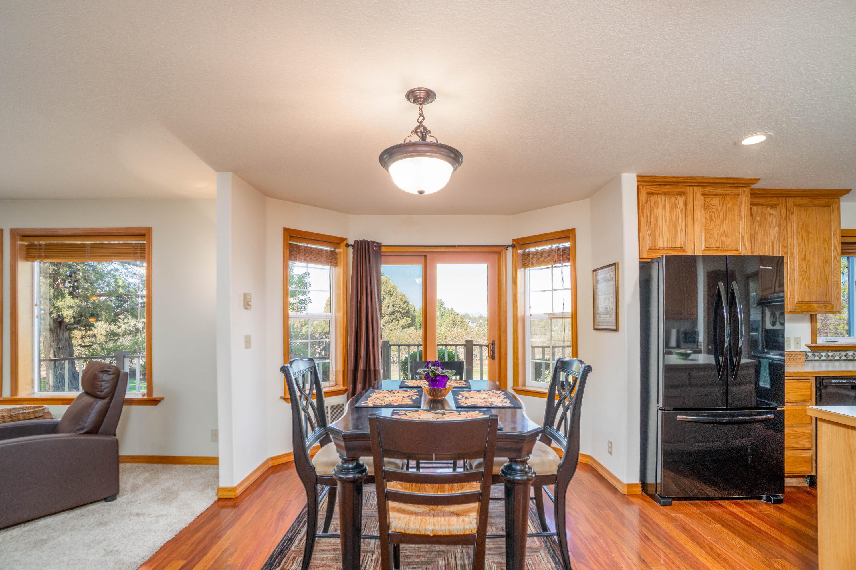 60905 Jennings Road Bend, OR 97702 - Photo 11 of 41 Dining space in the great room with walk out to the back deck