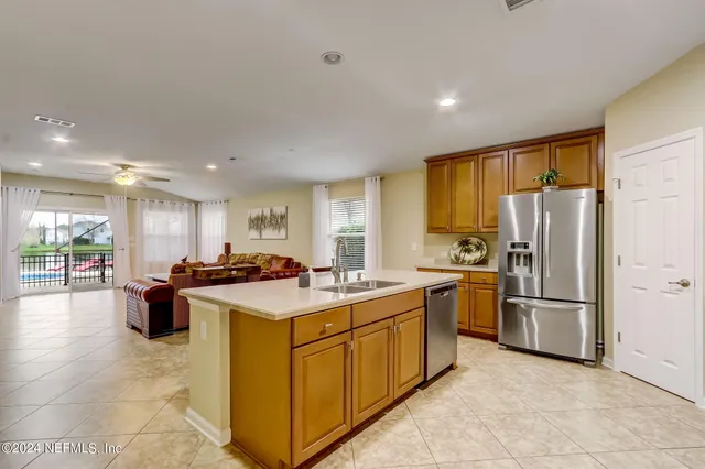 a kitchen with a stove a refrigerator and a sink