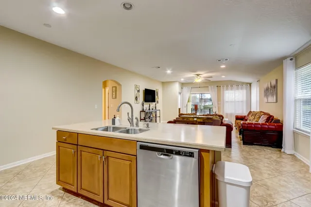 a kitchen with stainless steel appliances granite countertop a sink a stove and cabinets