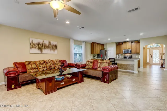 a living room with furniture and kitchen view