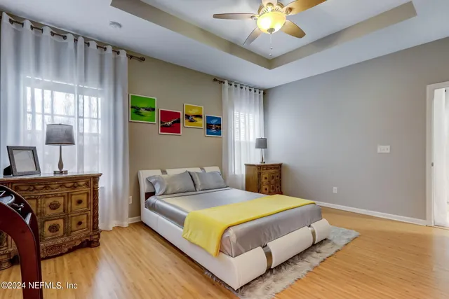 a bedroom with a bed and wooden floor