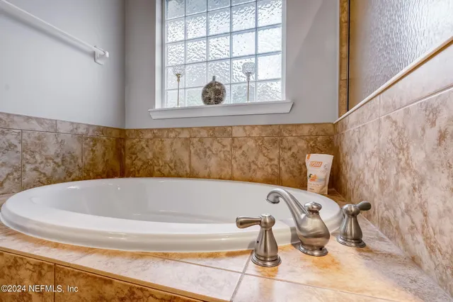 a bath tub sitting in a bathroom next to a window