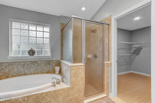 a bathroom with a bathtub and a shower