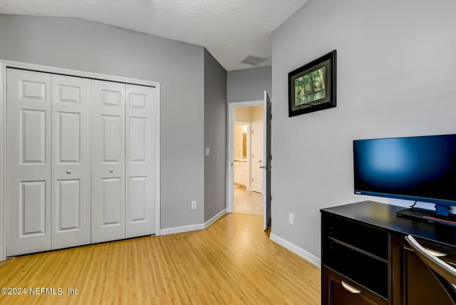 a view of room with window and wooden floor