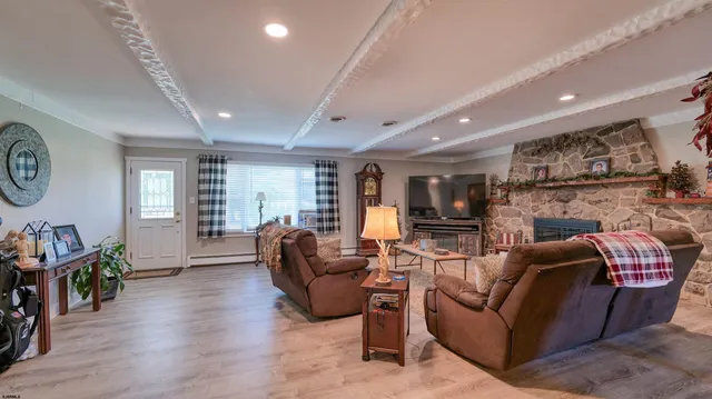 a living room with furniture fireplace and wooden floor