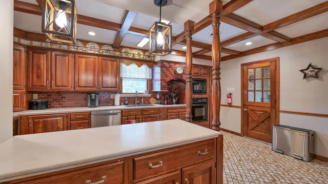 a kitchen with stainless steel appliances granite countertop a sink a stove and cabinets