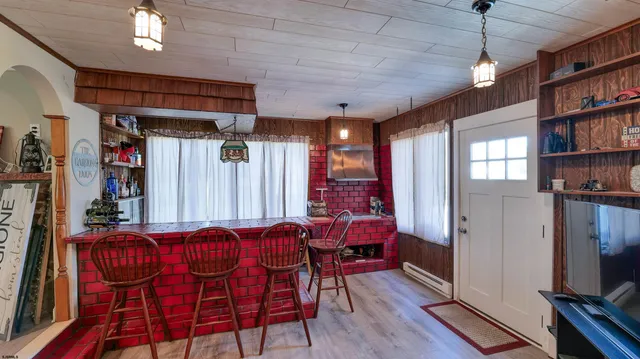 a dinning room with furniture and a flat screen tv
