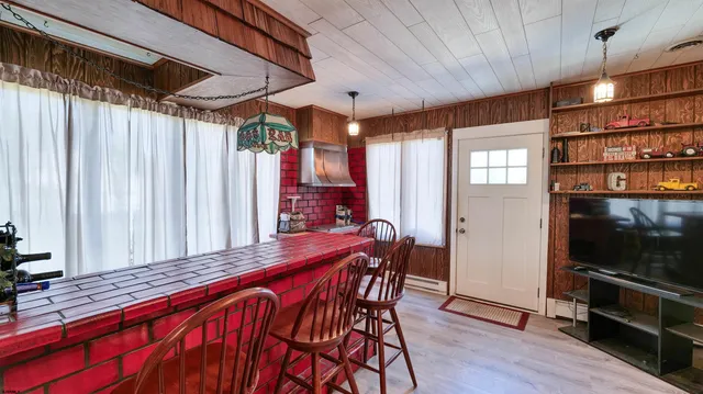 a outdoor space with a large window and wooden floor