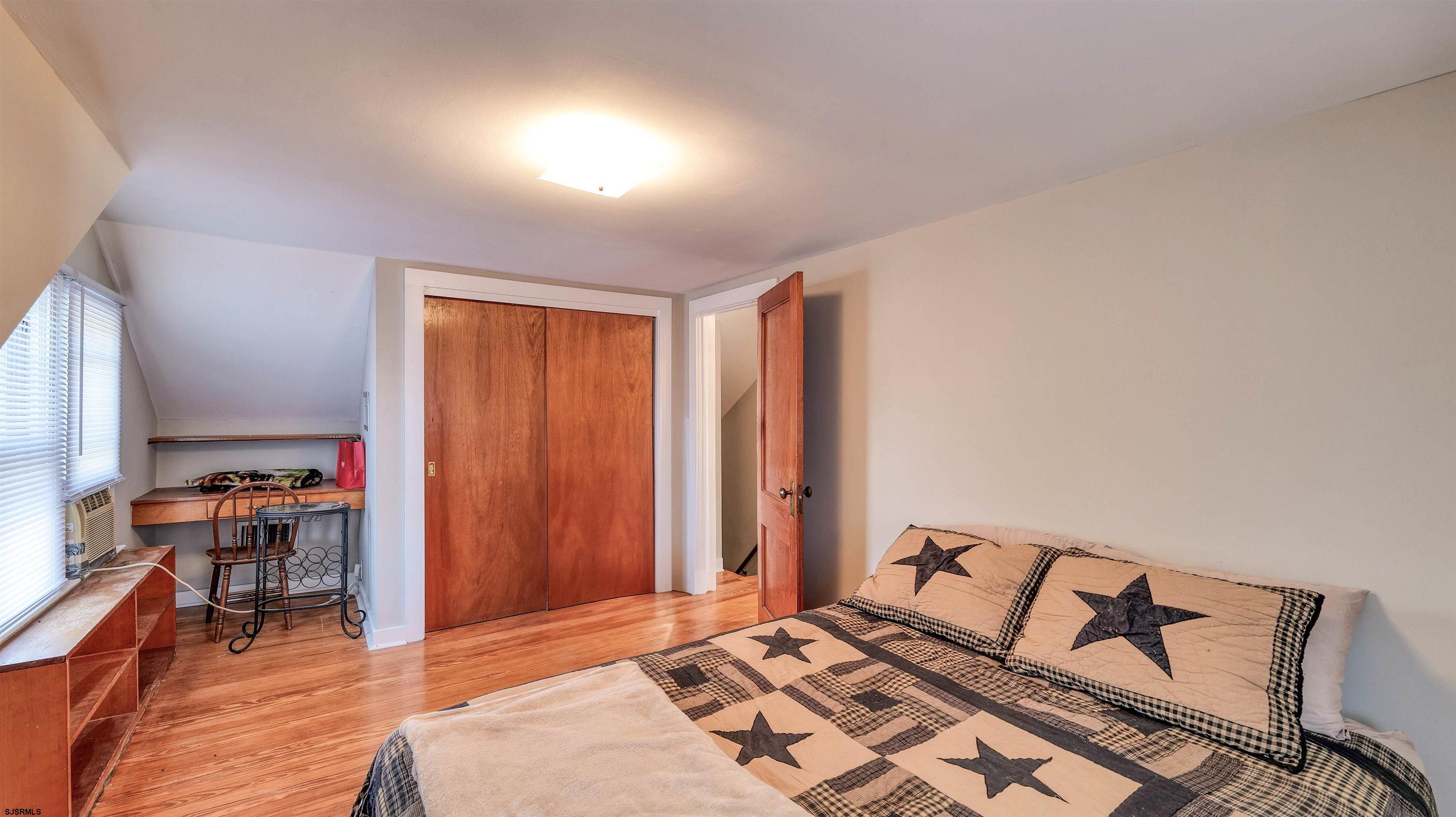328 Llewellyn Avenue Richland, NJ 08350 - Photo 31 of 44 a bedroom with a bed and a bookshelf with wooden floor