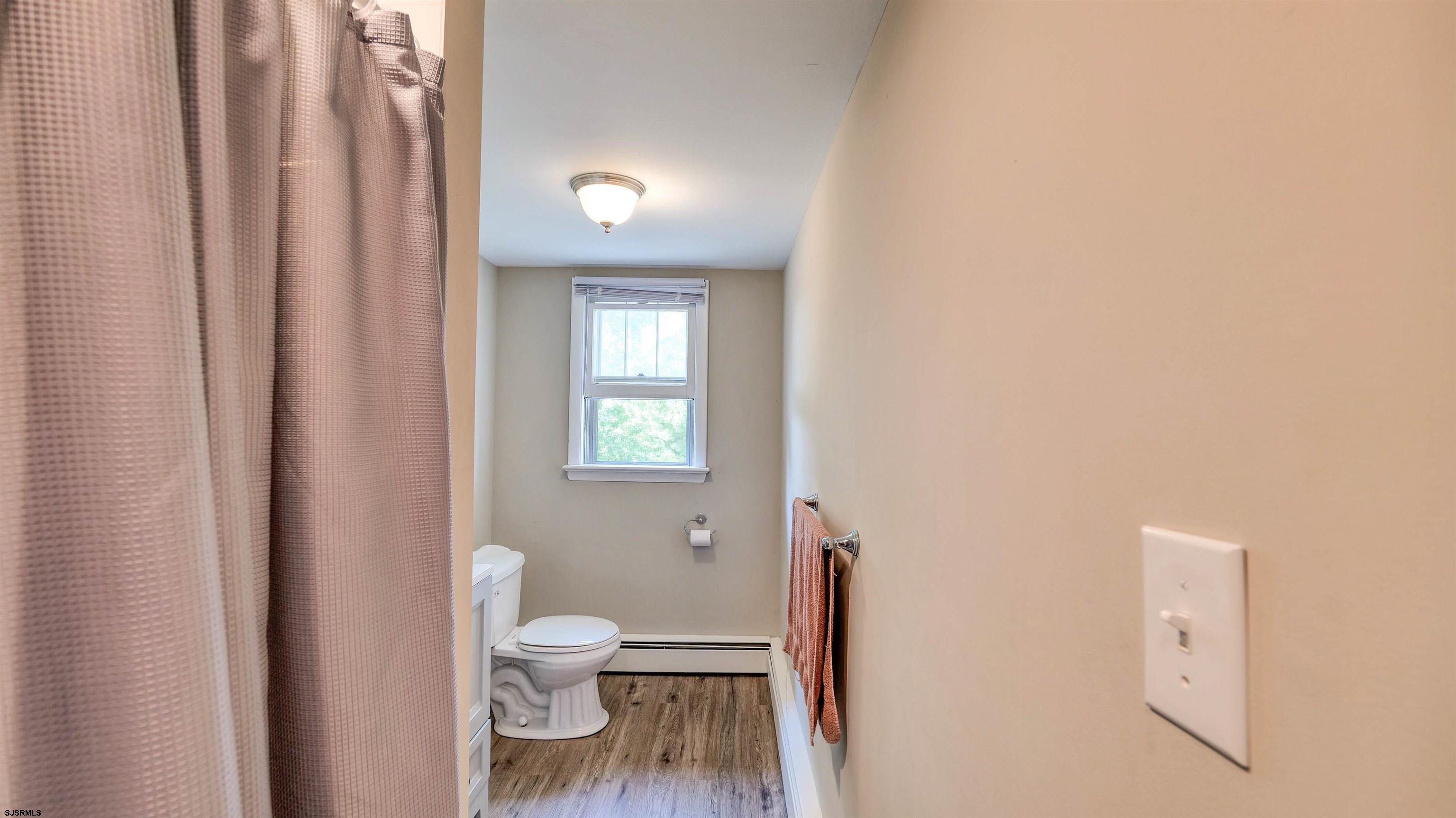 328 Llewellyn Avenue Richland, NJ 08350 - Photo 32 of 44 a bathroom with a toilet a sink and a window