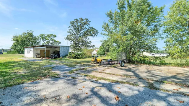 a view of a house with backyard and sitting area