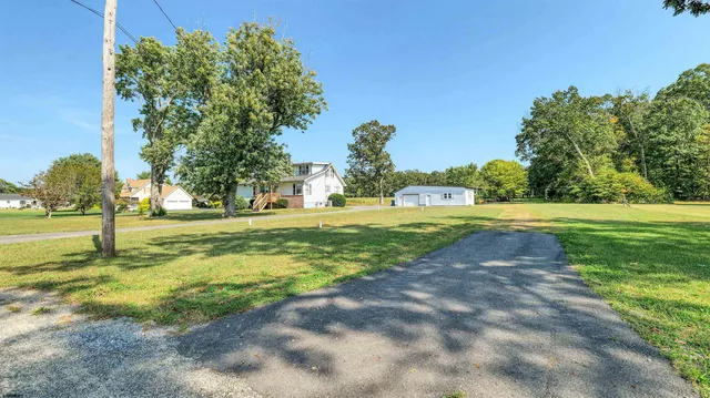 a view of a yard with basketball court