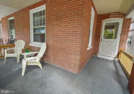 a couple of chairs sitting in front of a house