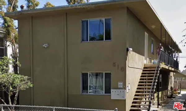 a front view of a house with a black gate