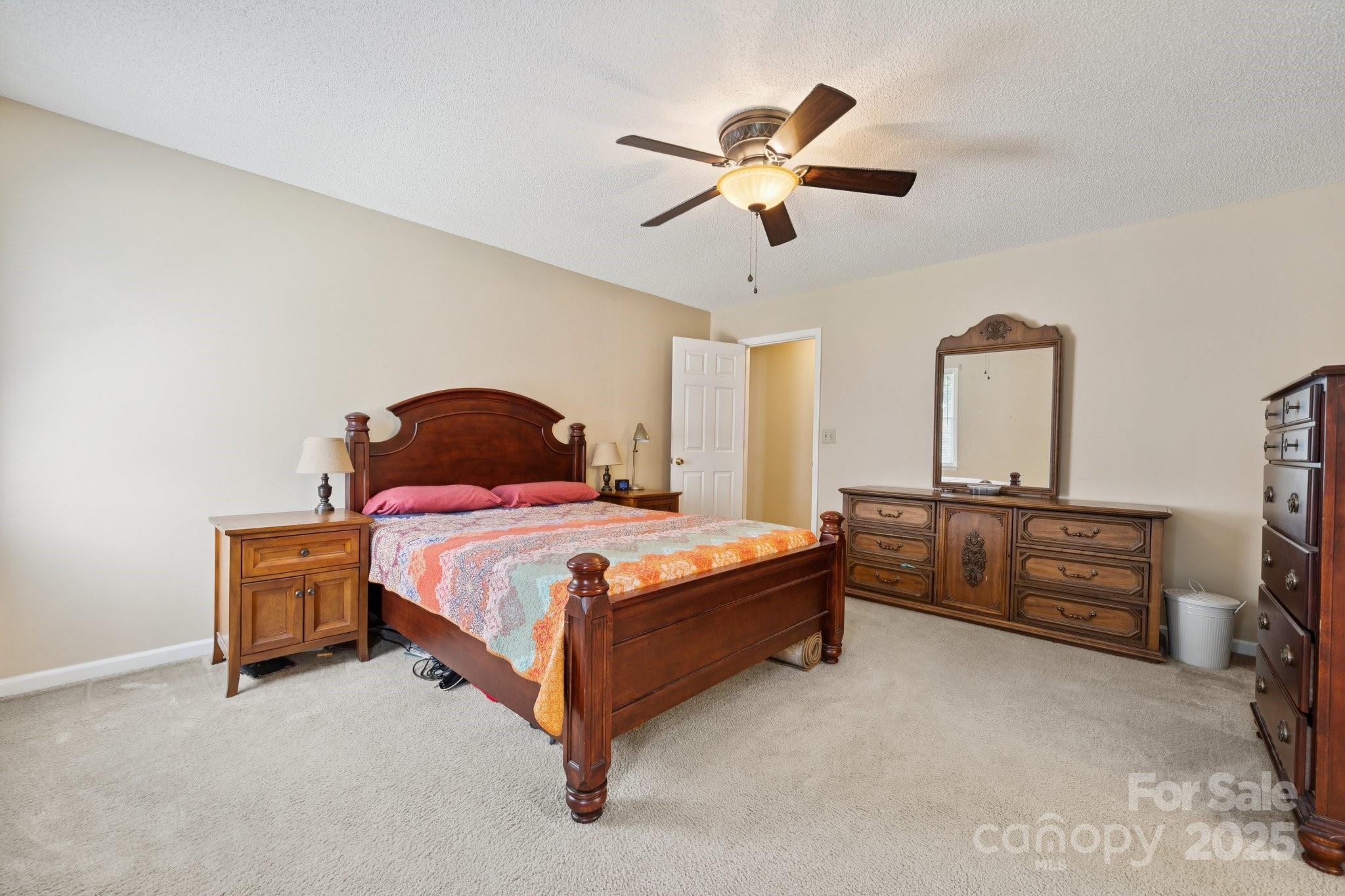 1106 Birch Street Salisbury, NC 28146 - Photo 26 of 48 a bedroom with a bed and a chandelier