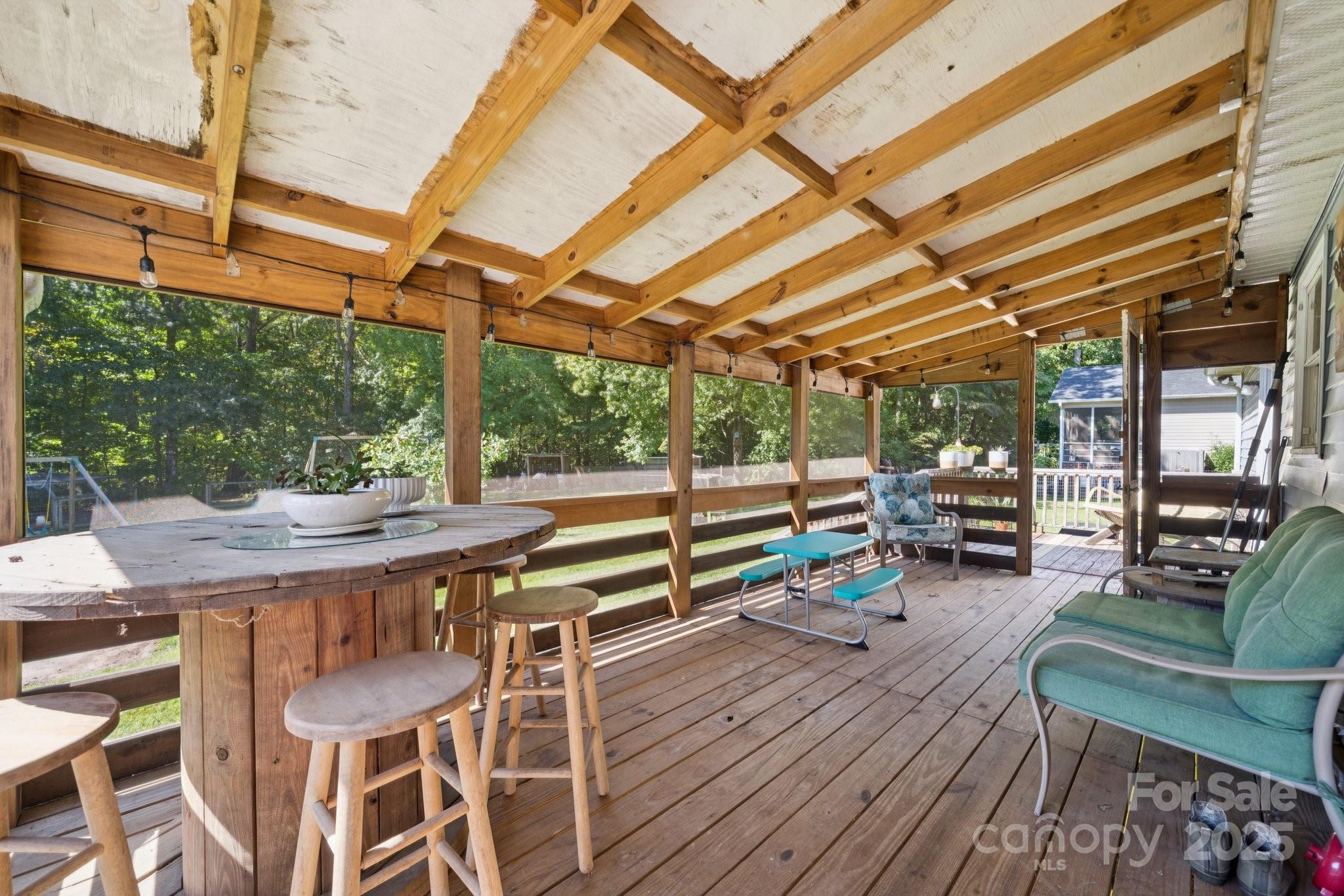 1106 Birch Street Salisbury, NC 28146 - Photo 37 of 48 a view of a patio with table and chairs a barbeque with wooden floor and roof with barbeque grill