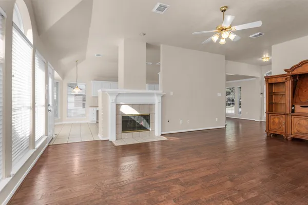 a view of a livingroom with furniture a ceiling fan and window