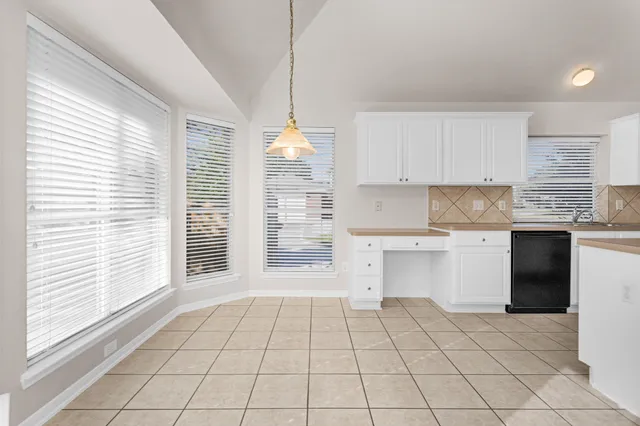 a kitchen with a stove a sink and a window