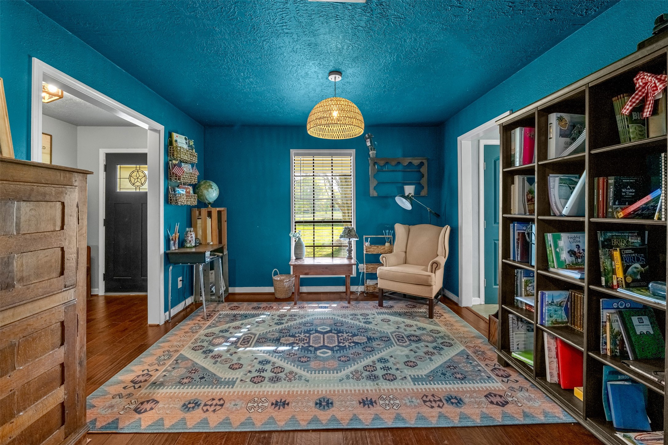 26515 Dobbin-Huffsmith Road Magnolia, TX 77354 - Photo 18 of 47 a living room with lots of furniture and a book shelf