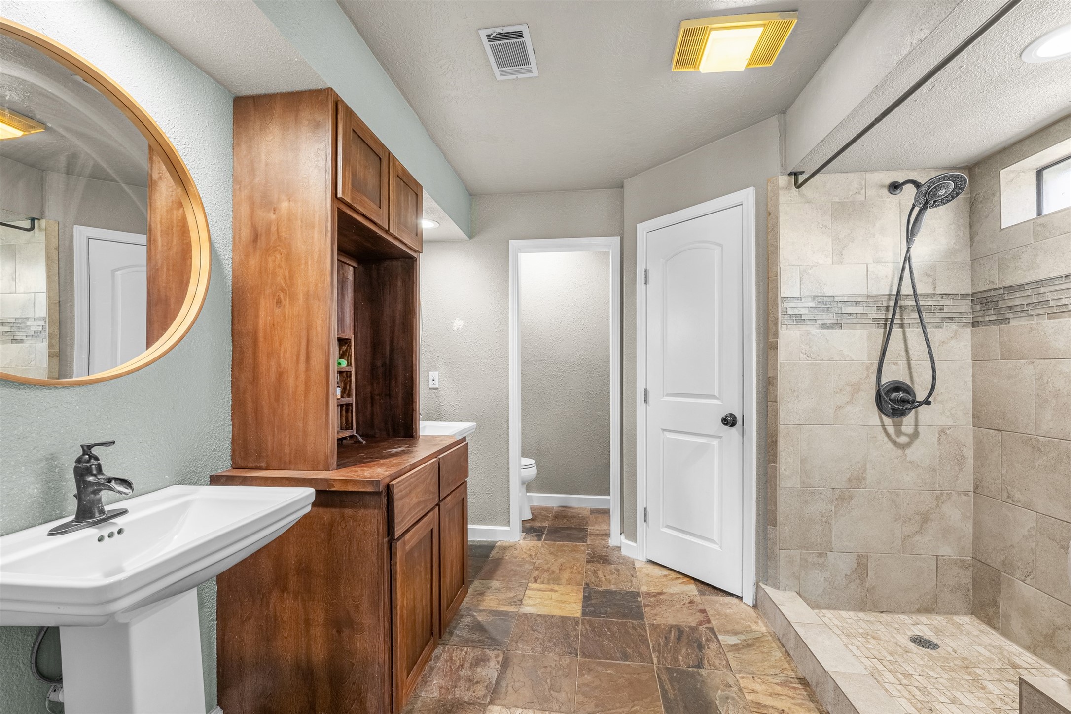 26515 Dobbin-Huffsmith Road Magnolia, TX 77354 - Photo 30 of 47 a spacious bathroom with a sink a mirror and a shower