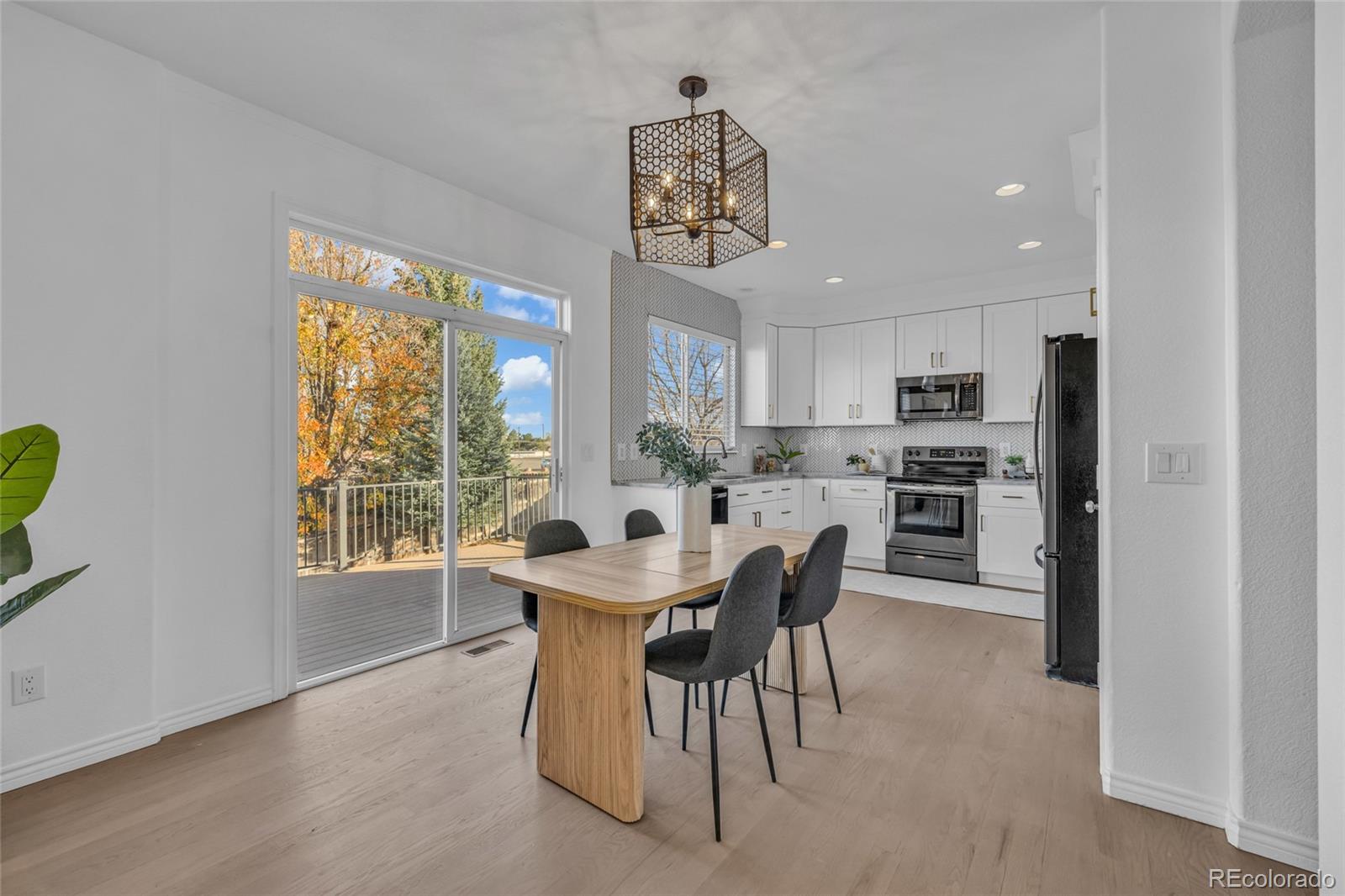 8204 Swadley Street Arvada, CO 80005 - Photo 11 of 39 a view of a dining room with furniture window and outside view