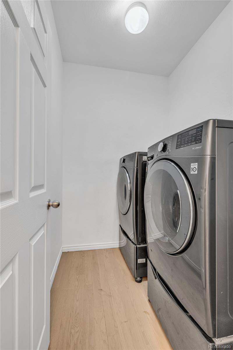 8204 Swadley Street Arvada, CO 80005 - Photo 14 of 39 a utility room with dryer and washer