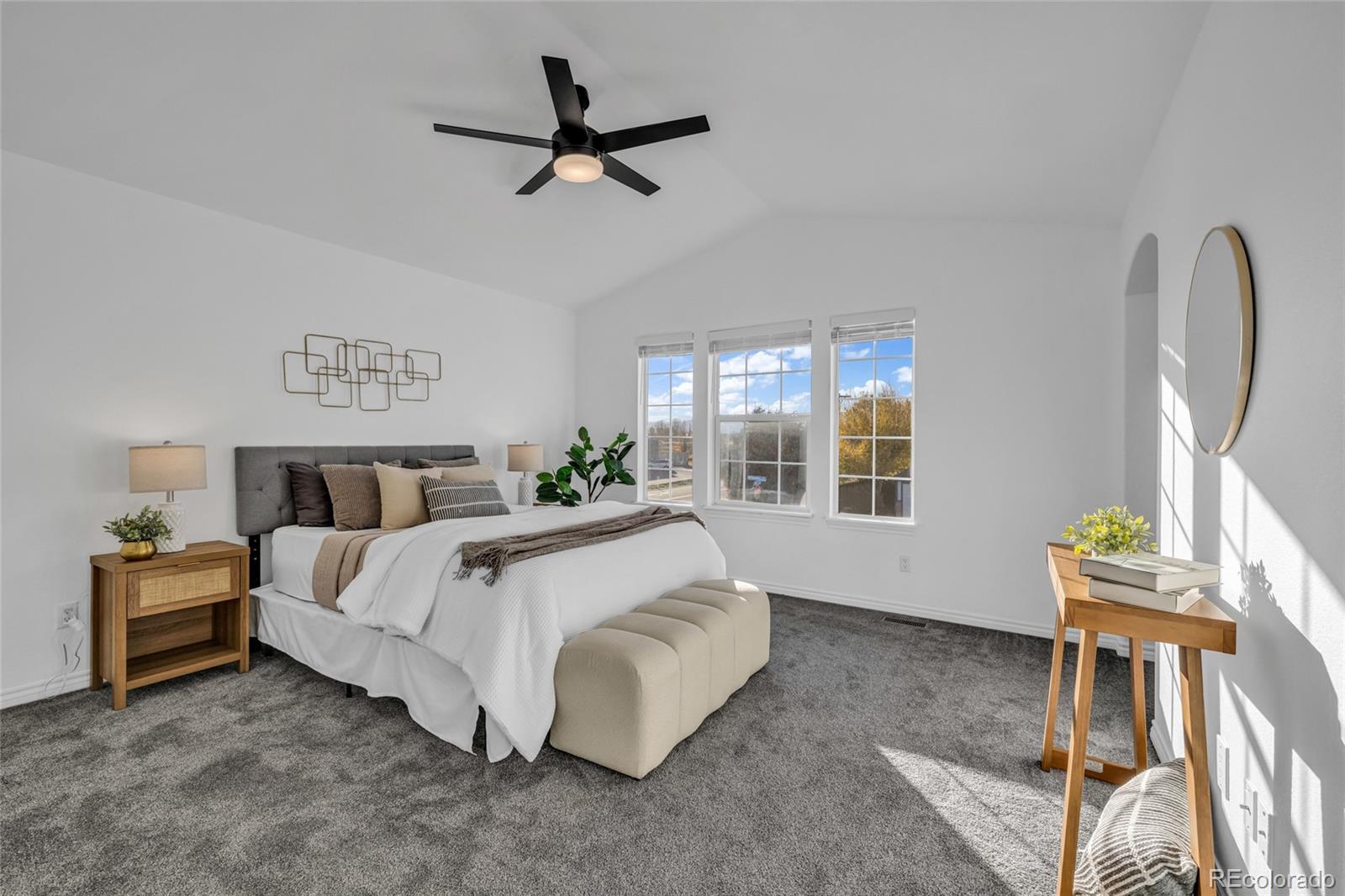 8204 Swadley Street Arvada, CO 80005 - Photo 15 of 39 a spacious bedroom with a bed a chandelier and a window