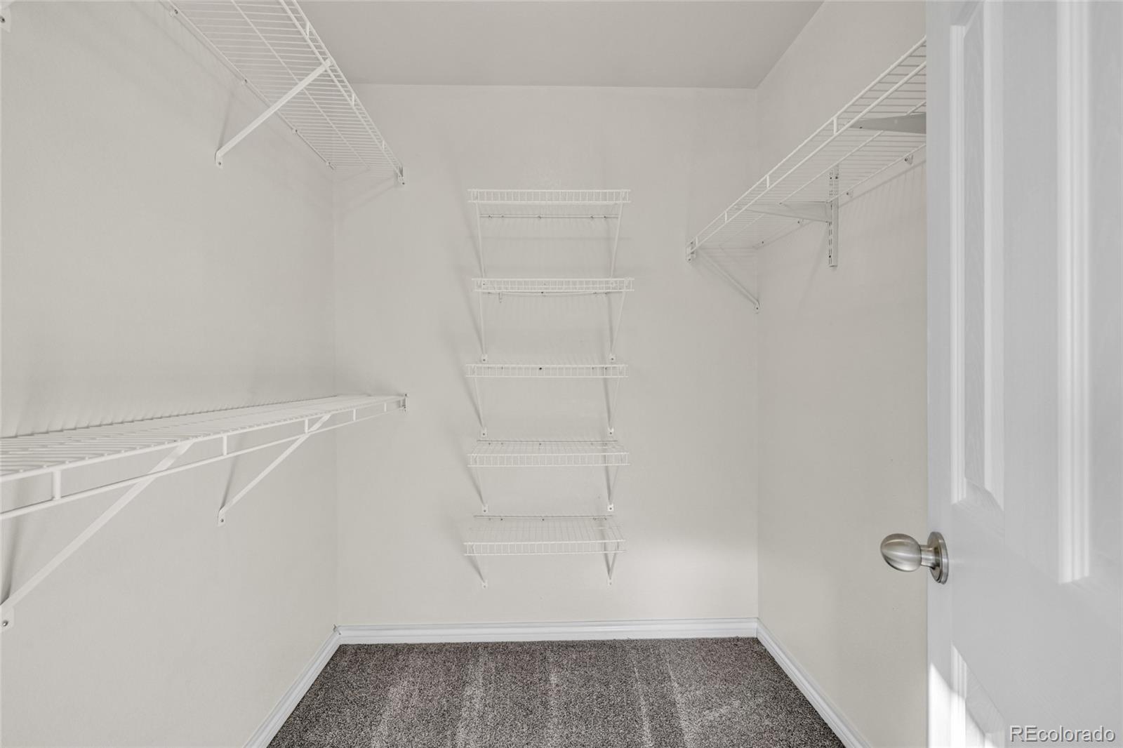 8204 Swadley Street Arvada, CO 80005 - Photo 20 of 39 a view of small space with racks on the wall