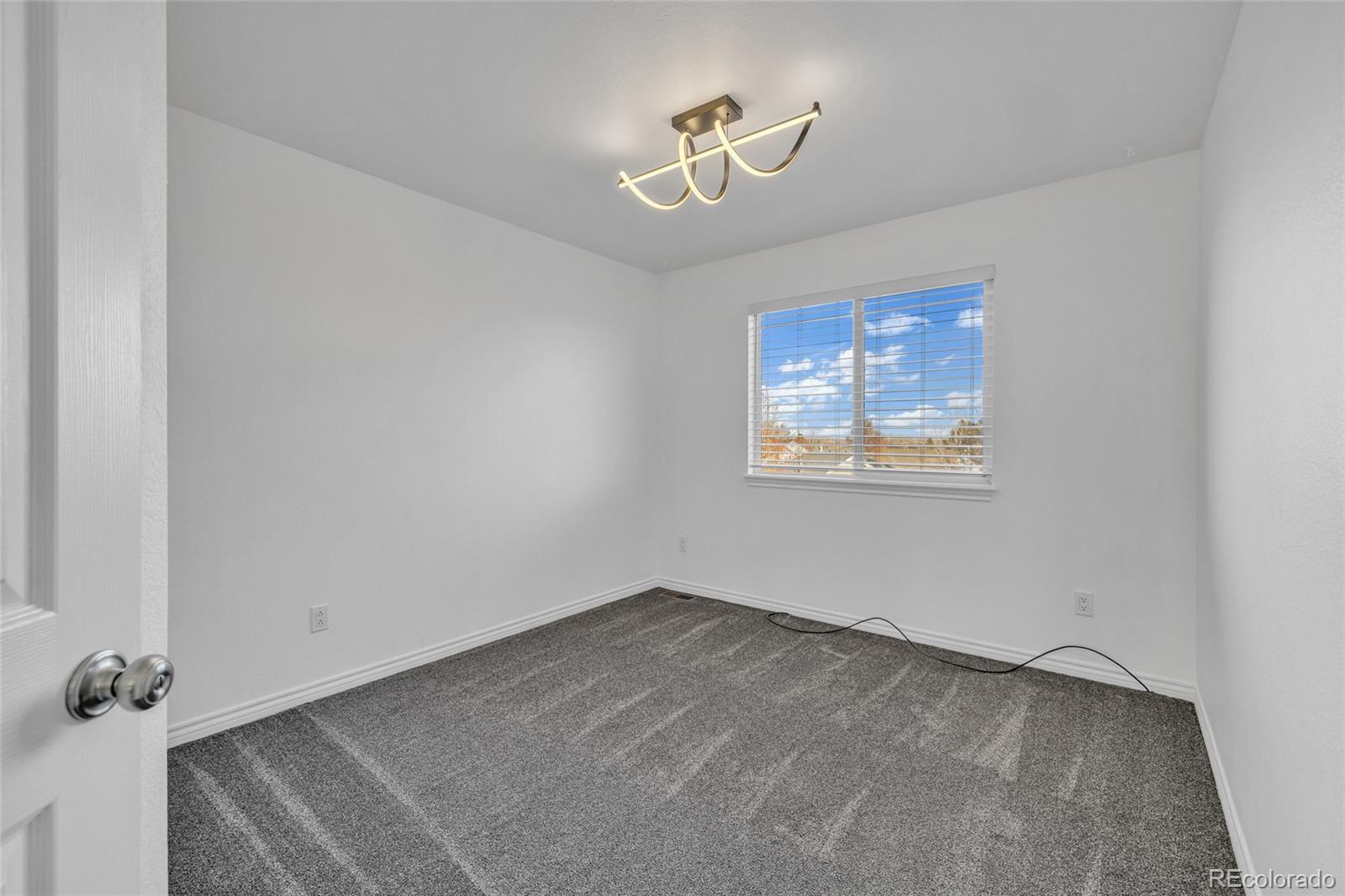 8204 Swadley Street Arvada, CO 80005 - Photo 24 of 39 a view of room with stairs and a window