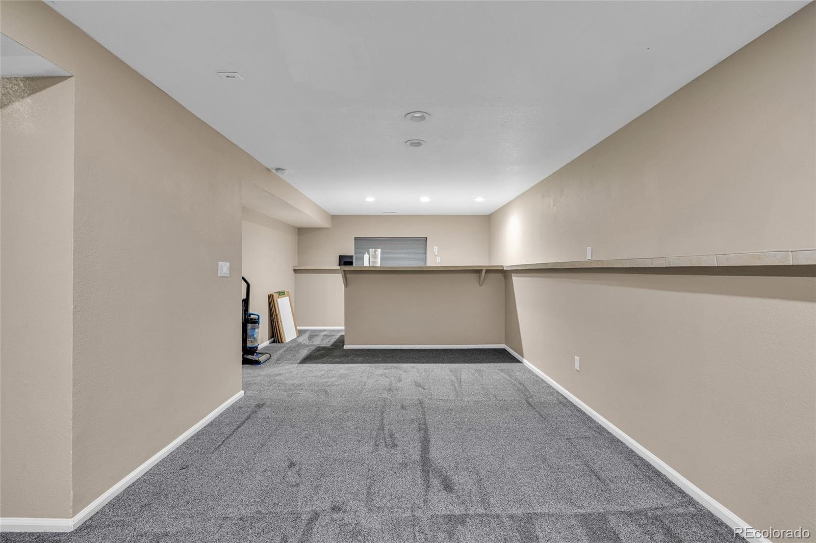 8204 Swadley Street Arvada, CO 80005 - Photo 28 of 39 a view of a big room with wooden floor and windows