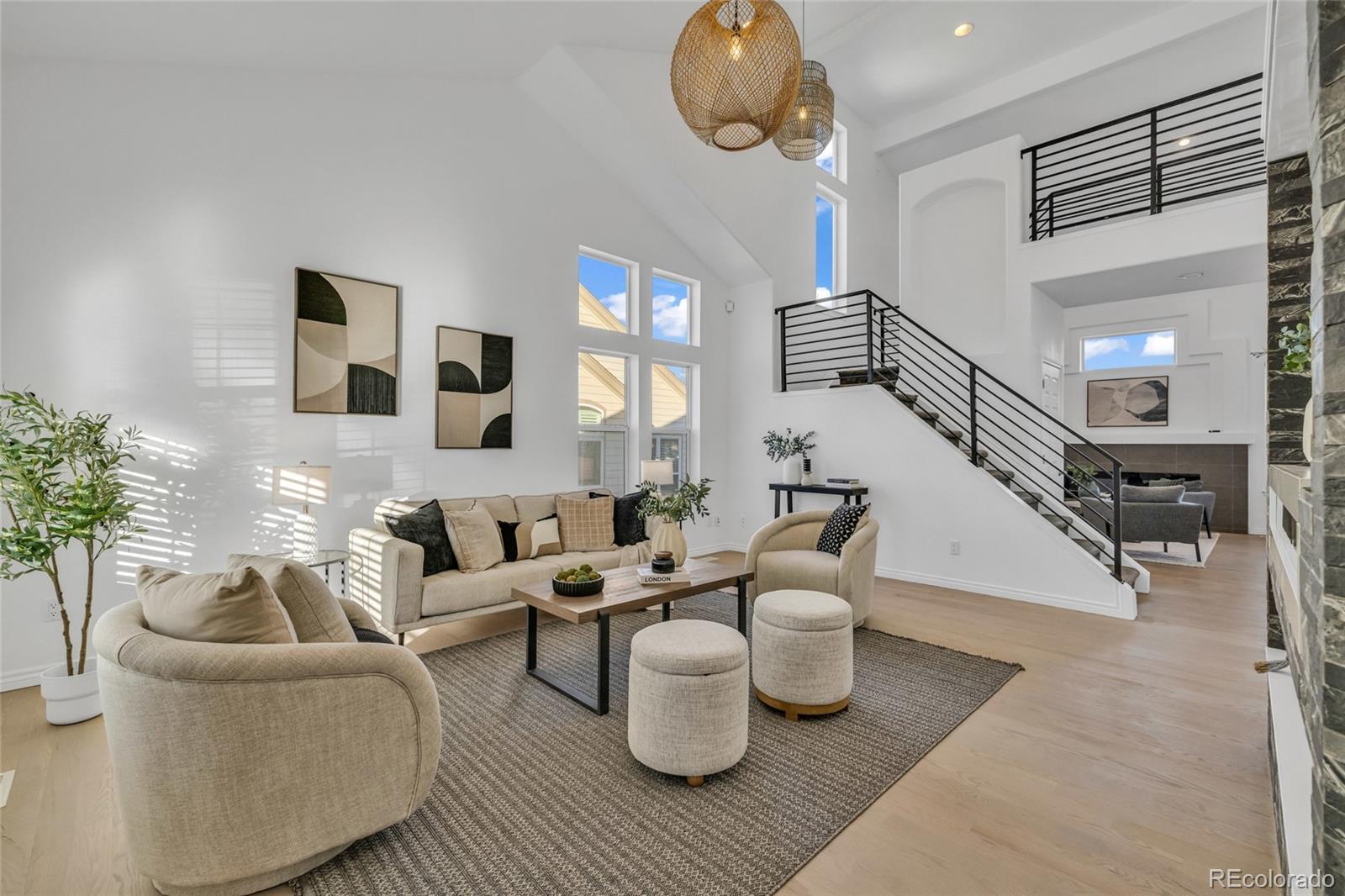 8204 Swadley Street Arvada, CO 80005 - Photo 5 of 39 a living room with furniture and wooden floor