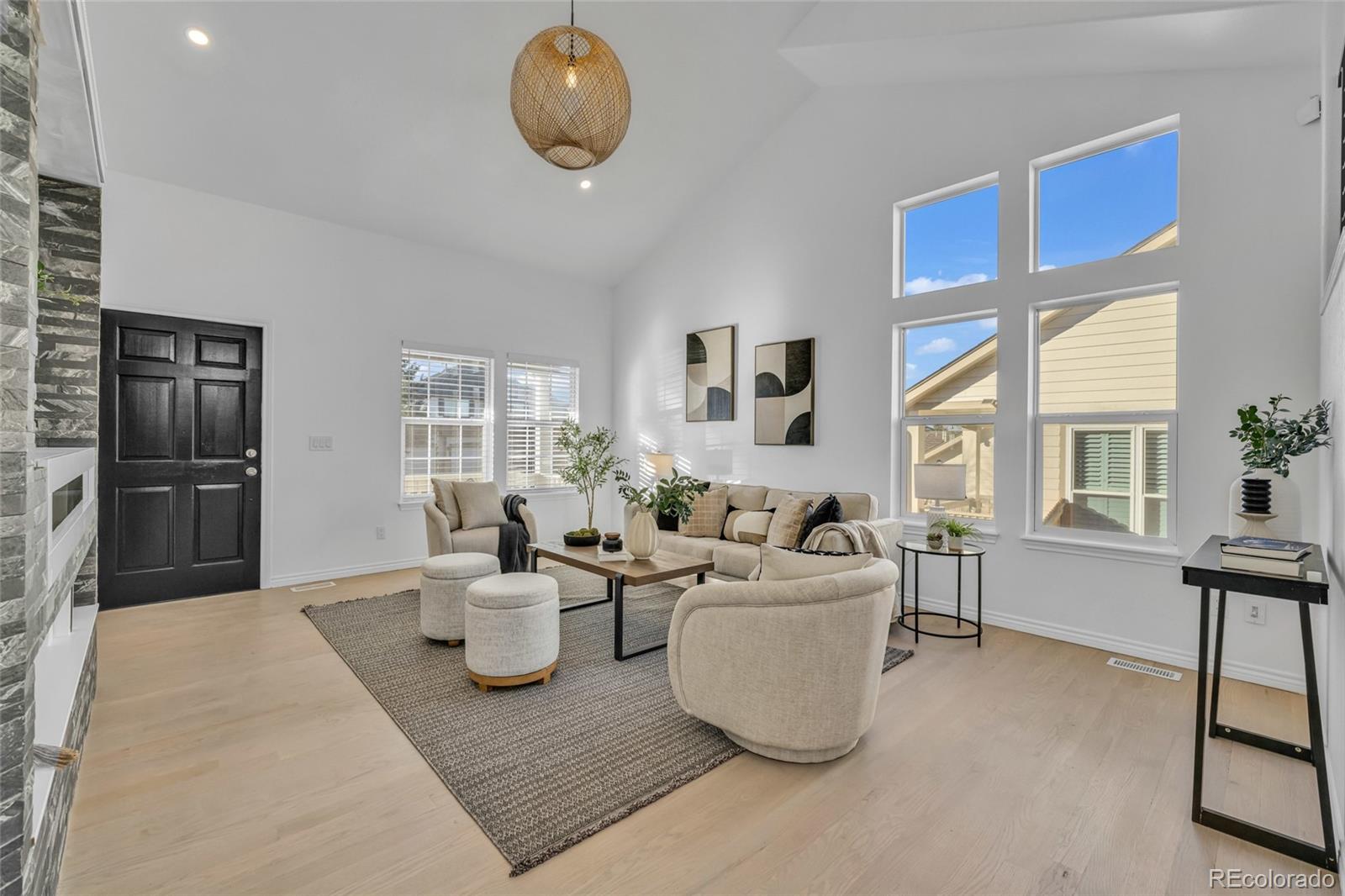 8204 Swadley Street Arvada, CO 80005 - Photo 7 of 39 a living room with furniture a large window and kitchen view