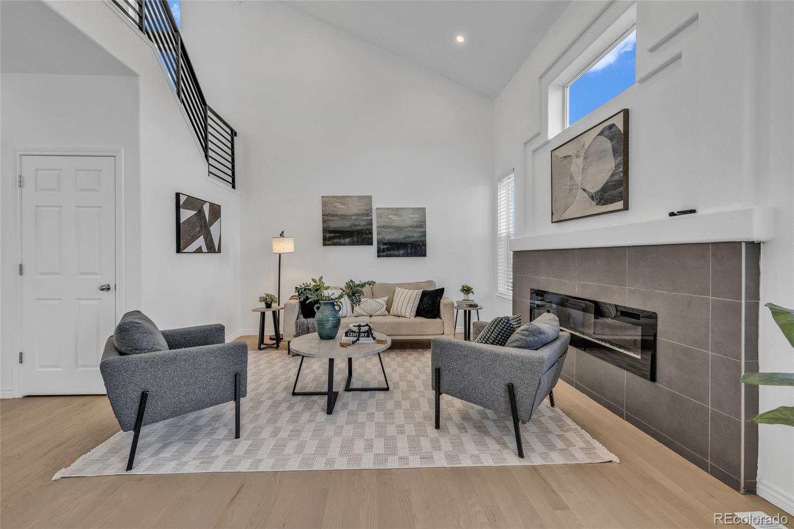 8204 Swadley Street Arvada, CO 80005 - Photo 8 of 39 a living room with furniture and a fireplace