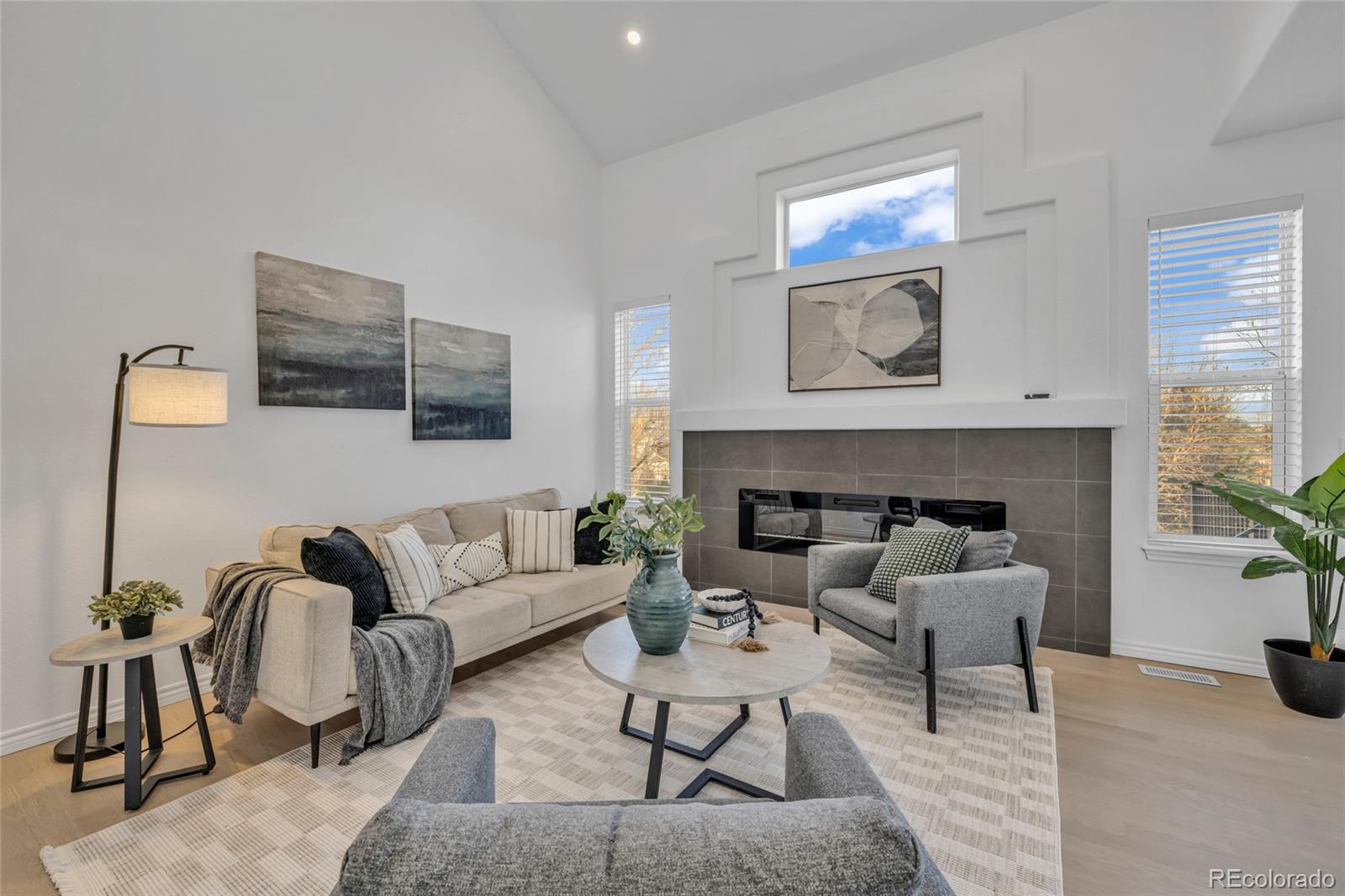 8204 Swadley Street Arvada, CO 80005 - Photo 9 of 39 a living room with furniture and a fireplace