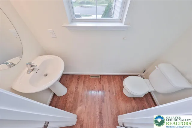 a bathroom with a sink mirror and toilet