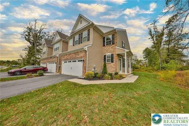 a front view of a house with a yard and garage