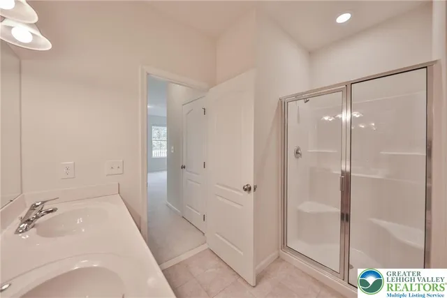 a bathroom with a shower and a tub