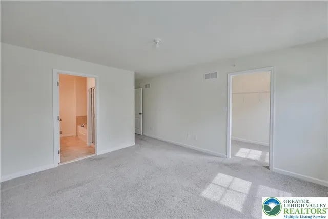 a view of an empty room and a window