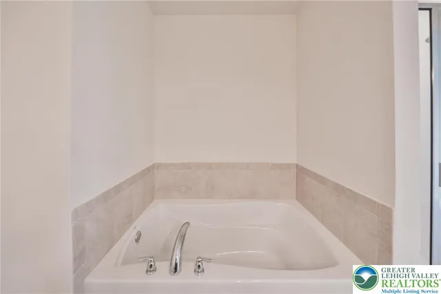 a white bath tub sitting in a bathroom