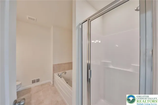 a bathroom with a bathtub and shower