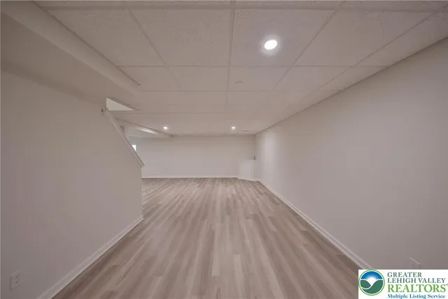 a view of an empty room and wooden floor