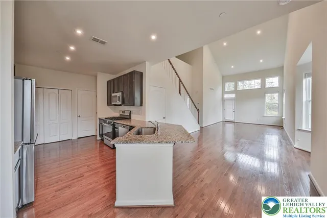 a view of a kitchen with furniture and wooden floor
